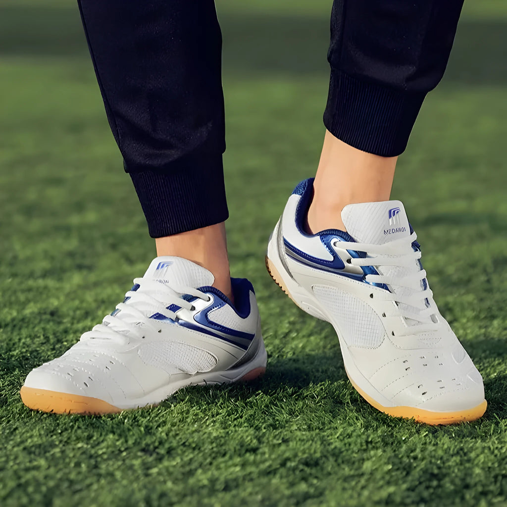 White table tennis sneakers with mesh upper and rubber sole in red or blue accents