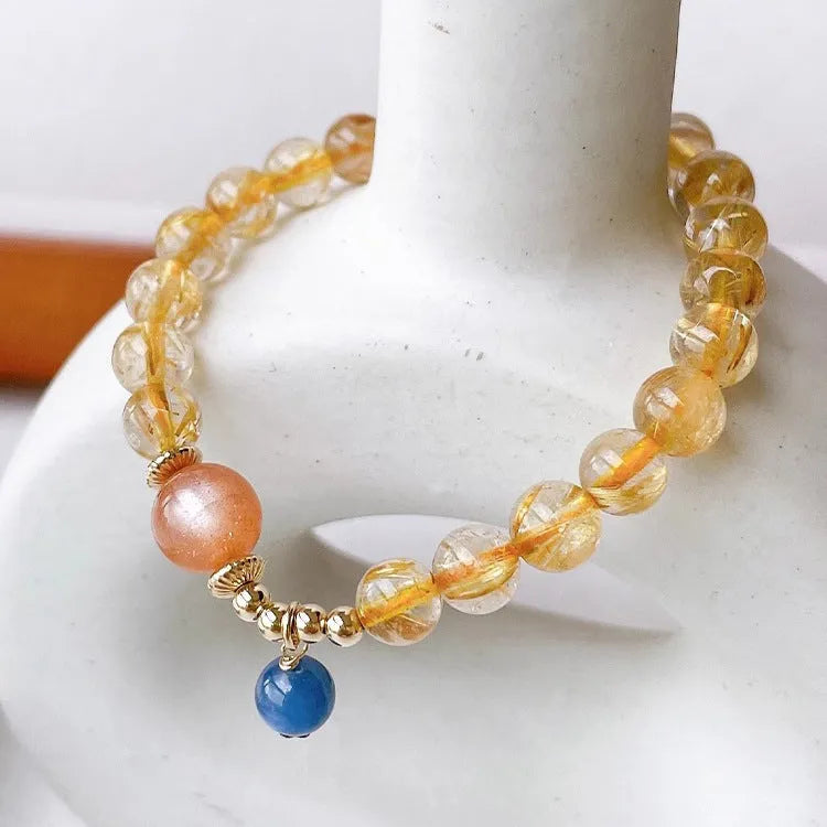 Women's gold rutilated quartz sunstone crystal bracelet with round beads in diamond pattern
