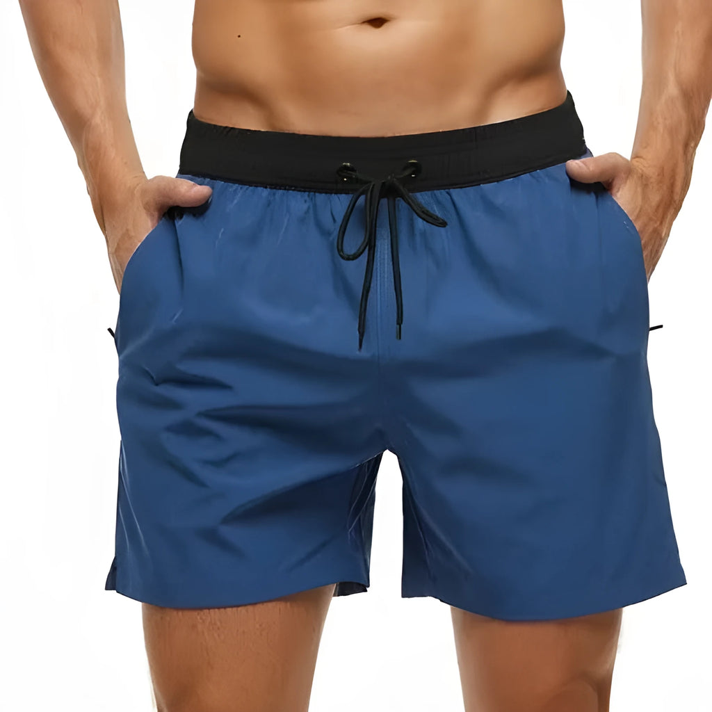 Men's blue stitching waist athletic shorts with drawstring and zipper pockets laid flat.