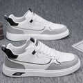 Men's low-top canvas trainers in black, beige, and grey with mesh lining and leather stitching.