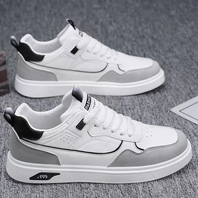 Men's low-top canvas trainers in black, beige, and grey with mesh lining and leather stitching.
