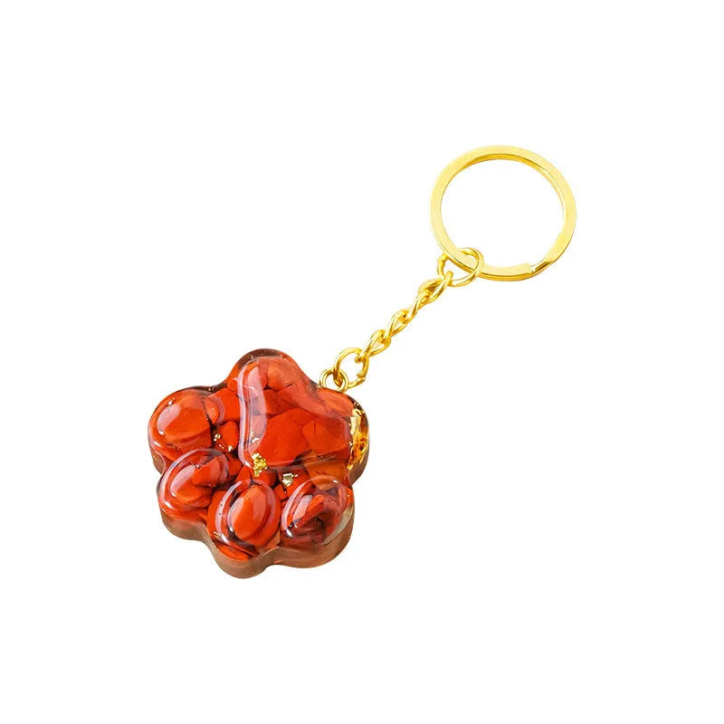 Small metal cat's paw keychain pendant with a set natural crystal charm.
