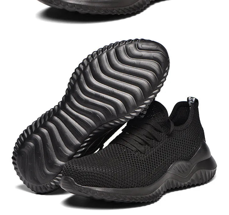 Low-cut black safety shoes with a steel toe cap on a plain background.