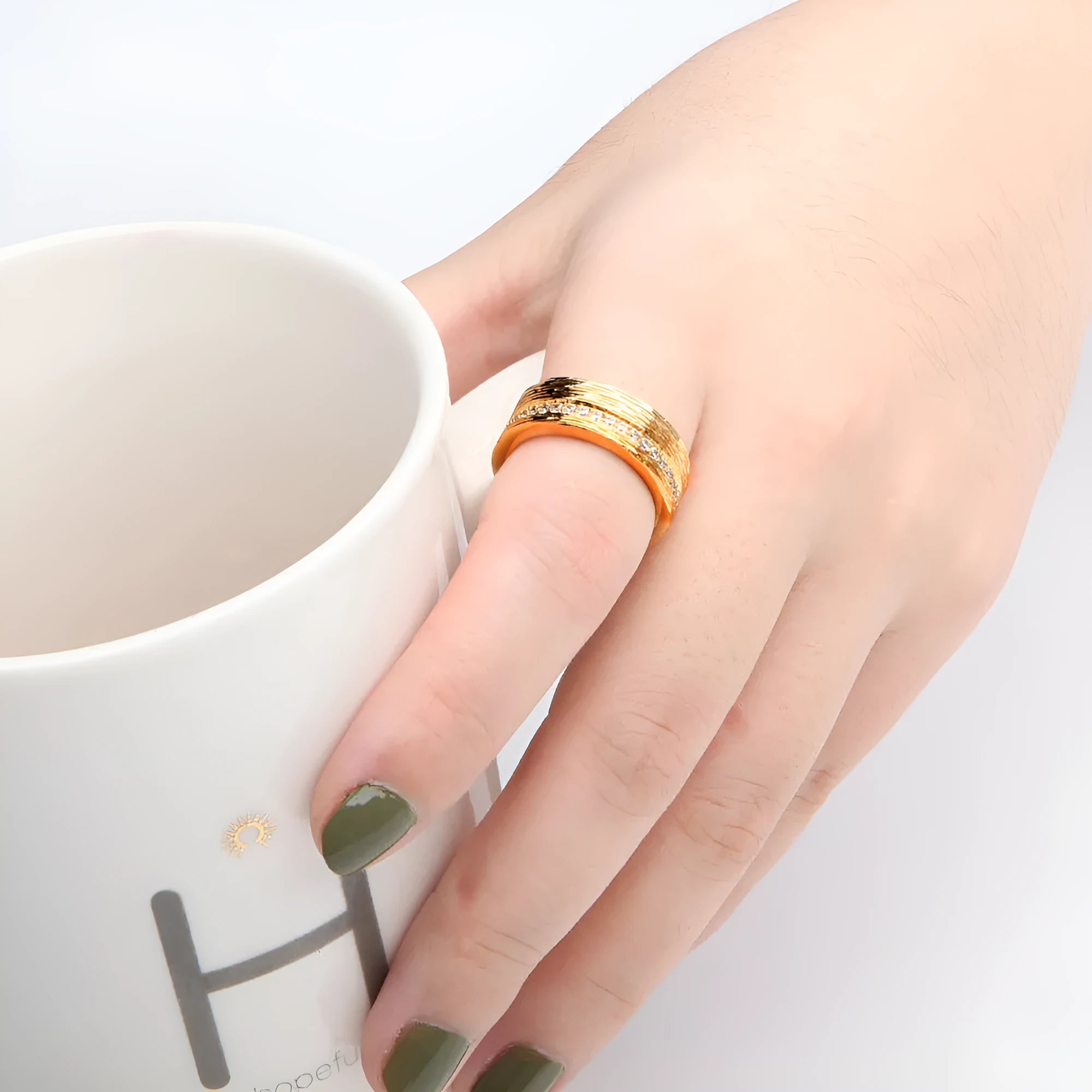 Gold geometric women's zircon ring made from electroplated copper on a grey background.