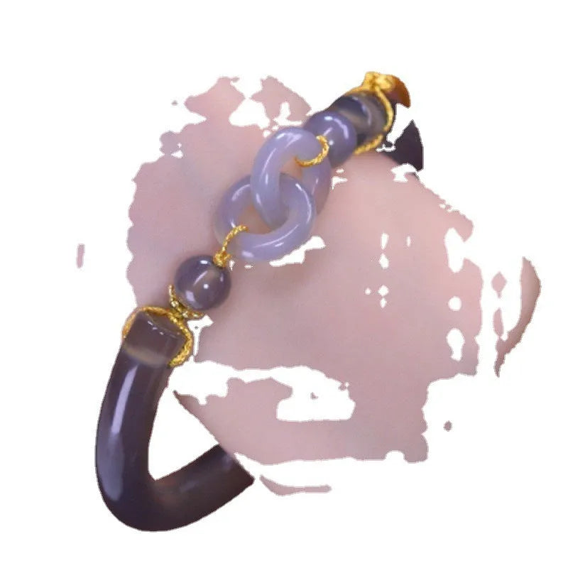 Grey smoke purple agate half bracelet with a metal ring buckle closure on a wrist.