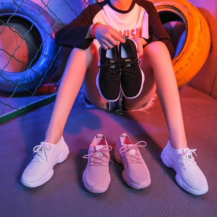 White women's thick-soled casual trainers with woven upper and front strap closure