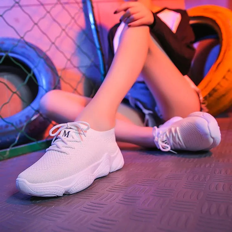 White women's thick-soled casual trainers with woven upper and front strap closure