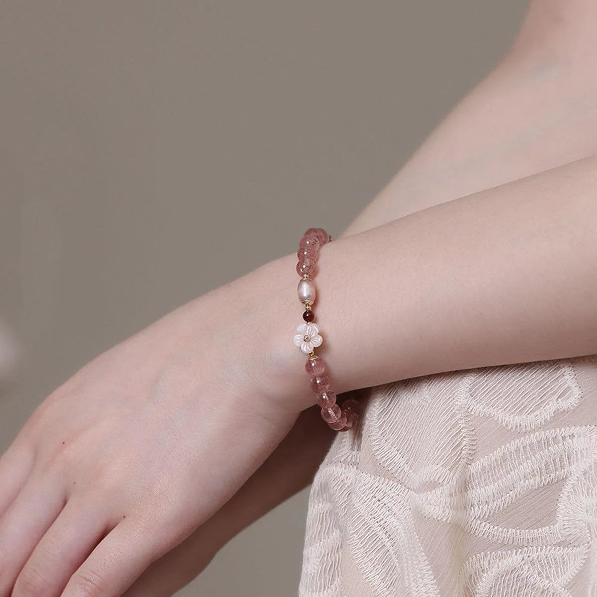Strawberry quartz crystal bracelet with floral peach blossom design and silver-tone metal fittings
