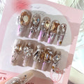 Rhinestone embellished false nail patches in heavy industry luxury designs with card packaging