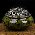 Retro ceramic incense burner in assorted glaze colours on a tabletop