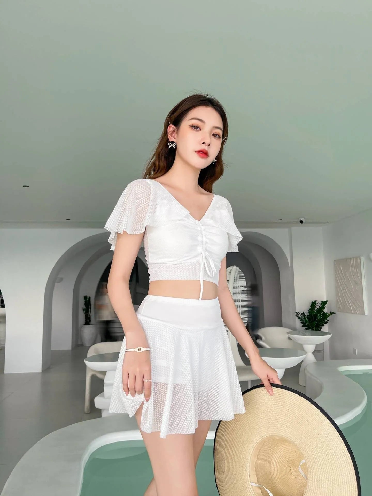 Women's solid colour two-piece skirt swimsuit set in black, white, or pink with separate top