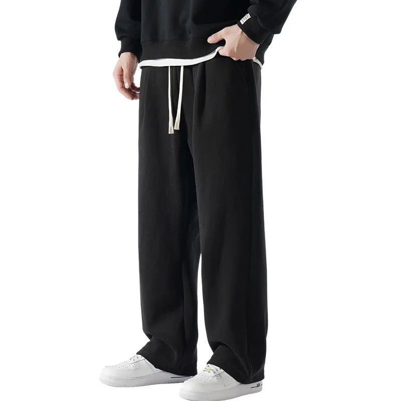 Man wearing apricot coloured loose-fit polar fleece winter sports pants with a drawstring waist.