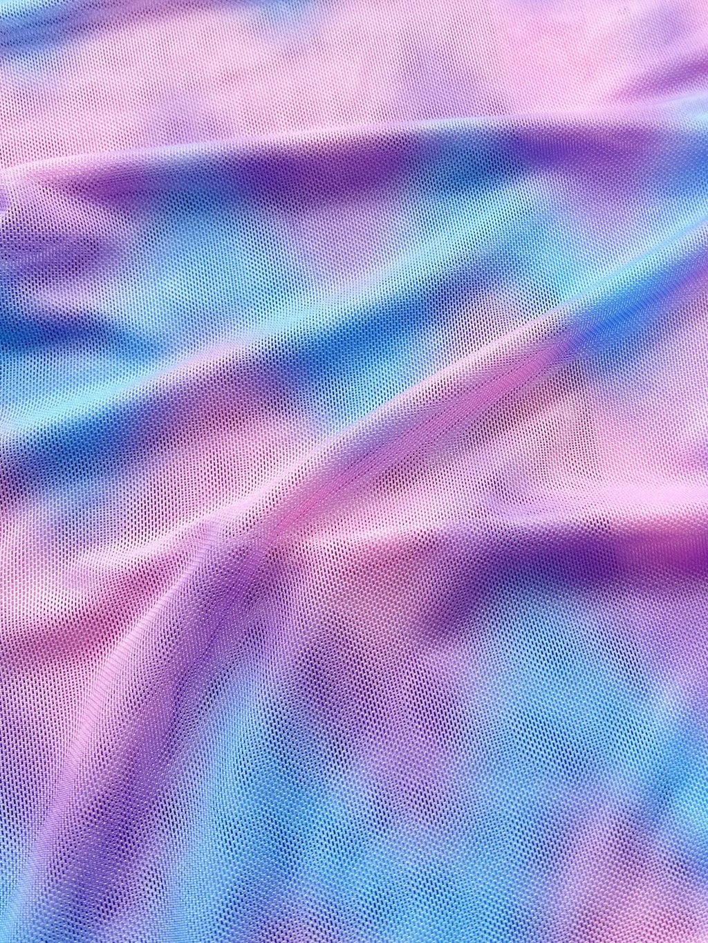 Women's tie-dye patterned bikini swimsuit set with bra, panties, and skirt.