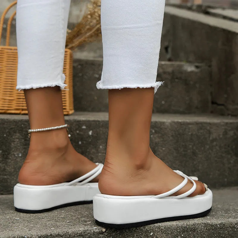 Pair of thick-soled flip-flops with herringbone-patterned PU uppers in a round-toe design