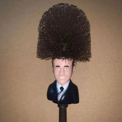 Yellow plastic Donald Trump novelty toilet brush with hanging handle, 40cm long