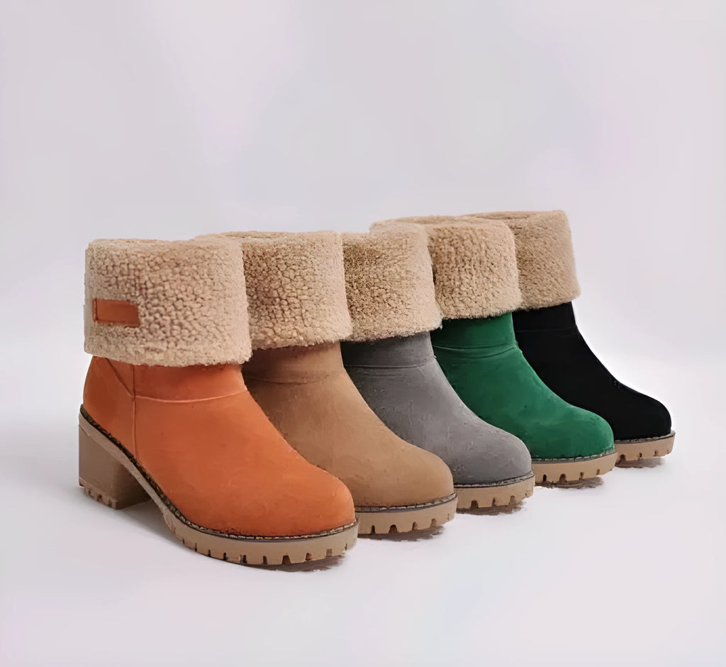 Women's black suede mid-tube snow boots with a thick flat heel and round toe on a white background.