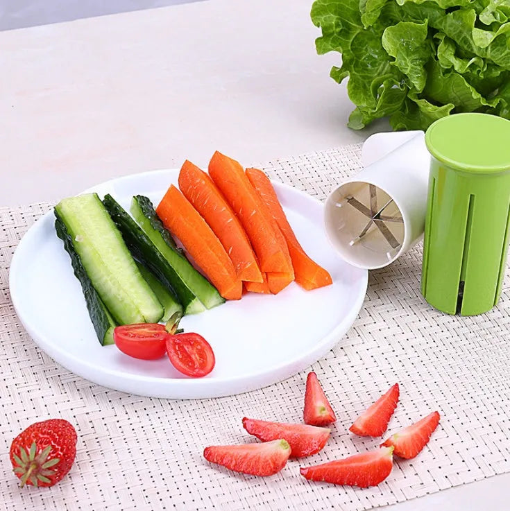 White kitchen slicer with six stainless steel blades for cutting cucumbers, carrots, and strawberries.