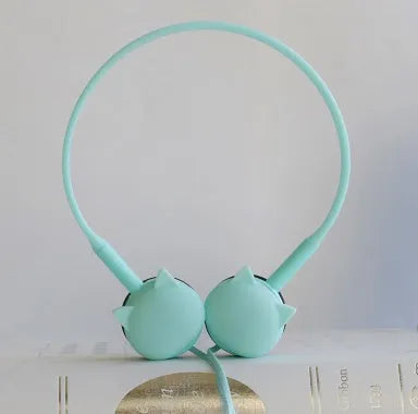 Cute cat stereo earphones with cat ear design in a choice of colours on a plain background