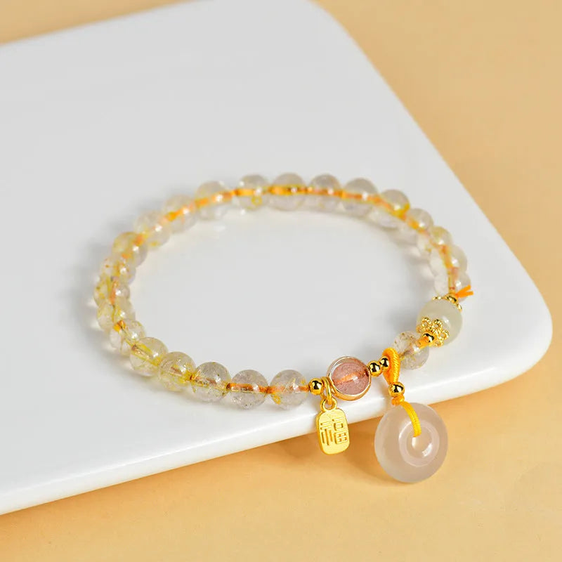 Gold rutilated quartz crystal bracelet with safety buckle and geometric pendant