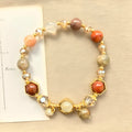 Gold citrine crystal bracelet with hand-woven construction showing auspicious Chinese symbols