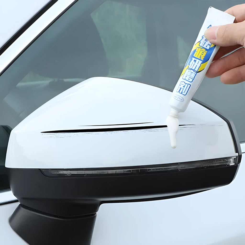 Automotive paint repair pen kit with touch-up fluid, wax, sponge, and sandpaper for car scratch repair.