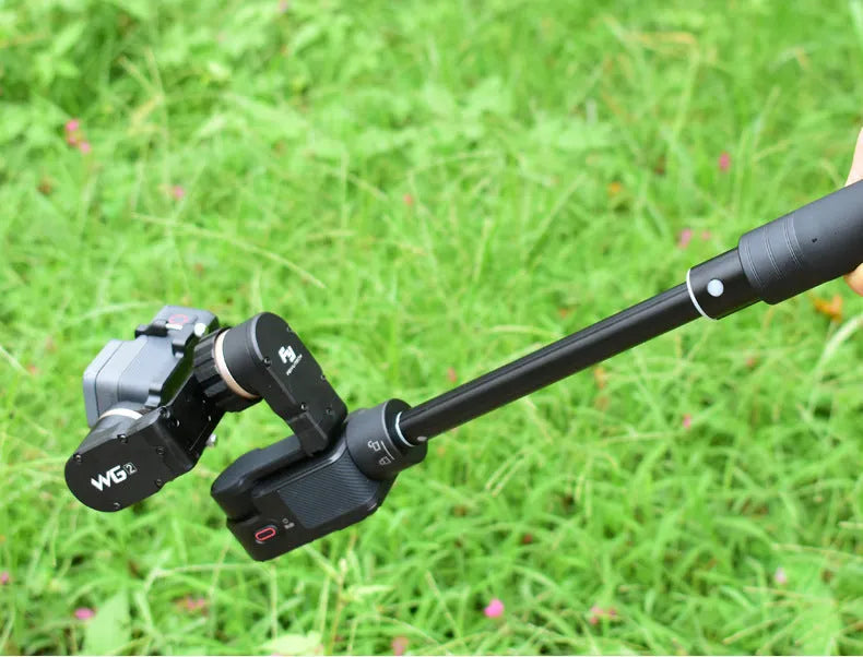 Black retractable aluminium selfie stick with foam grip, shown extended and collapsed.
