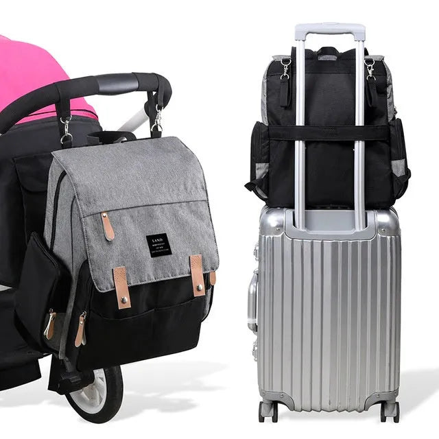 LAND Mommy Diaper Backpack in Oxford cloth with integrated changing mat, showing backpack straps and main compartment.