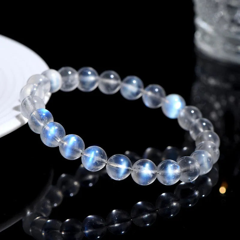 Natural cream body blue moonlight crystal bracelet showing grinding finish on wrist, available in single circle, strip or three ring designs.