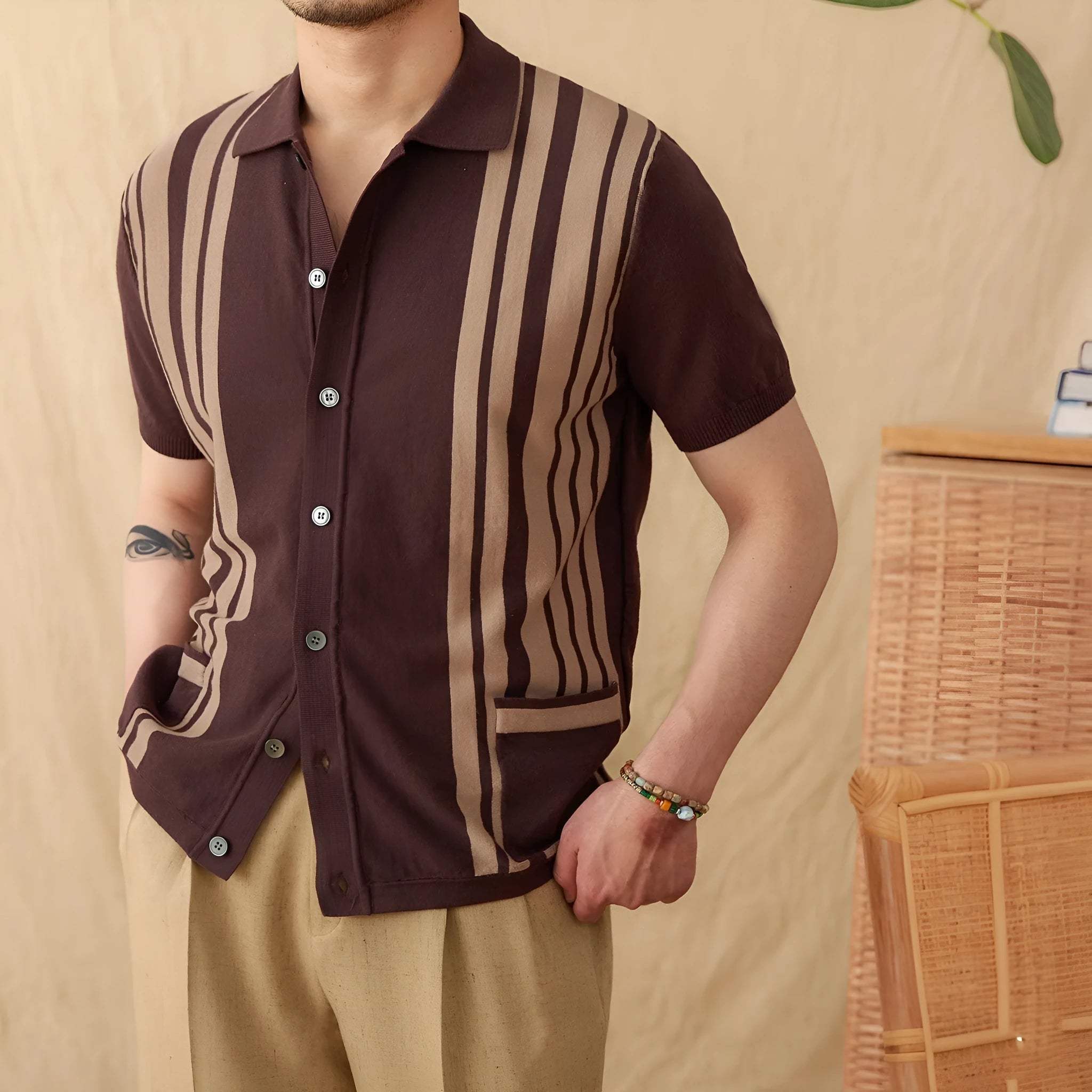 Short-sleeved striped knitted polo cardigan in light blue on a hanger.