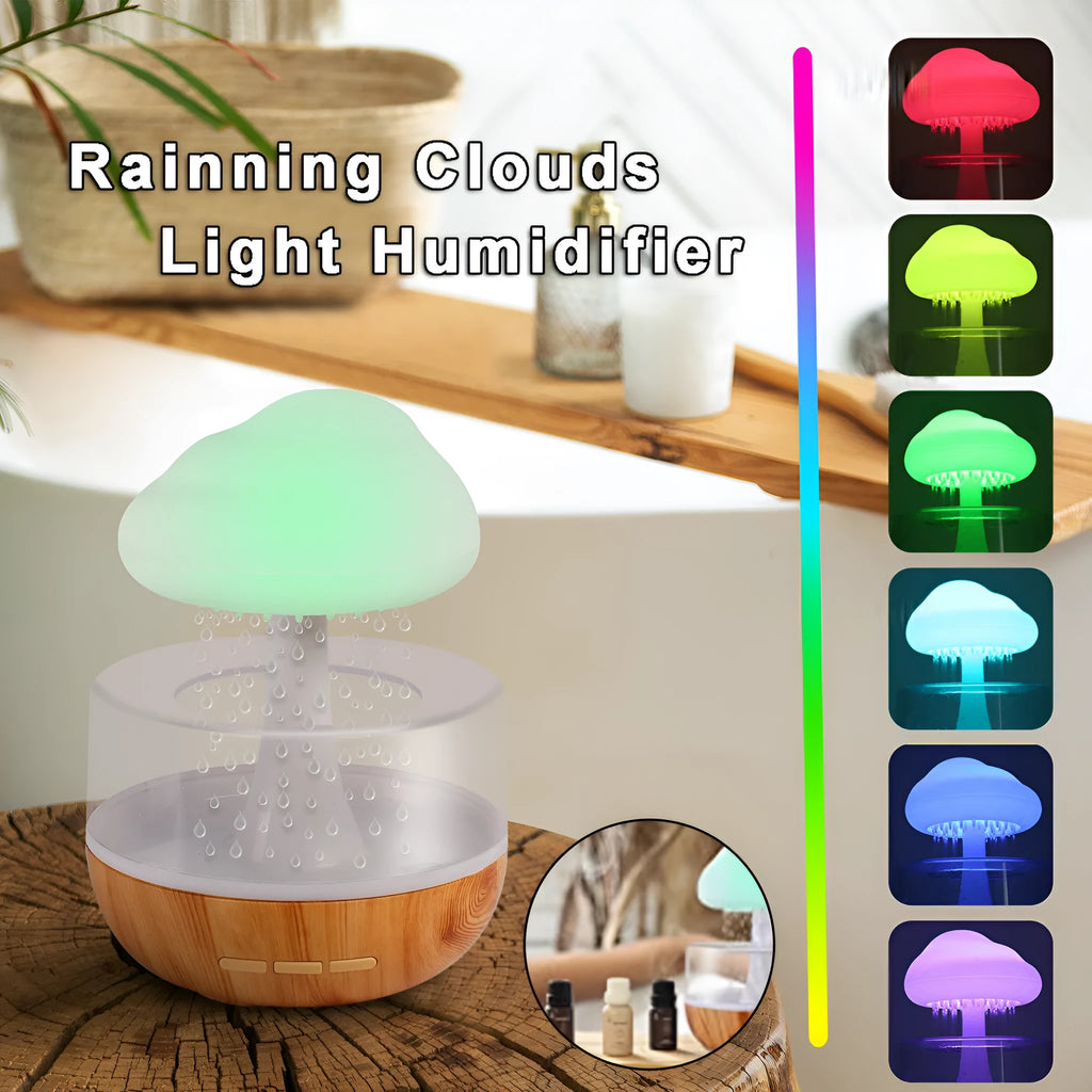 White cloud-shaped humidifier with multi-colour night light and essential oil diffuser on a table.