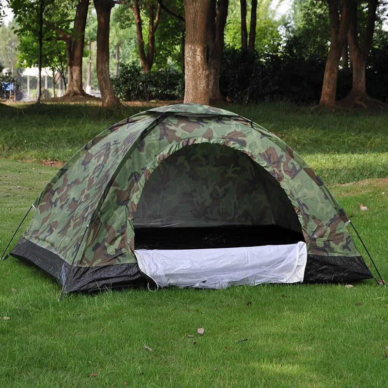 Green camouflage dome tent with mesh windows and steel ground nails setup outdoors