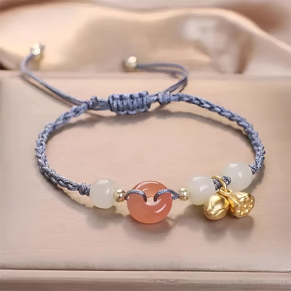Hetian jade peace buckle bracelet on a brown strap, showing constellation detail.