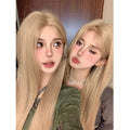 Women's long straight milk tea blonde wig on a stand with hair net.