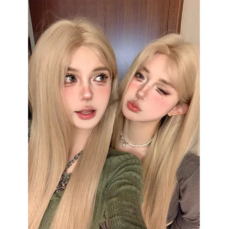 Women's long straight milk tea blonde wig on a stand with hair net.