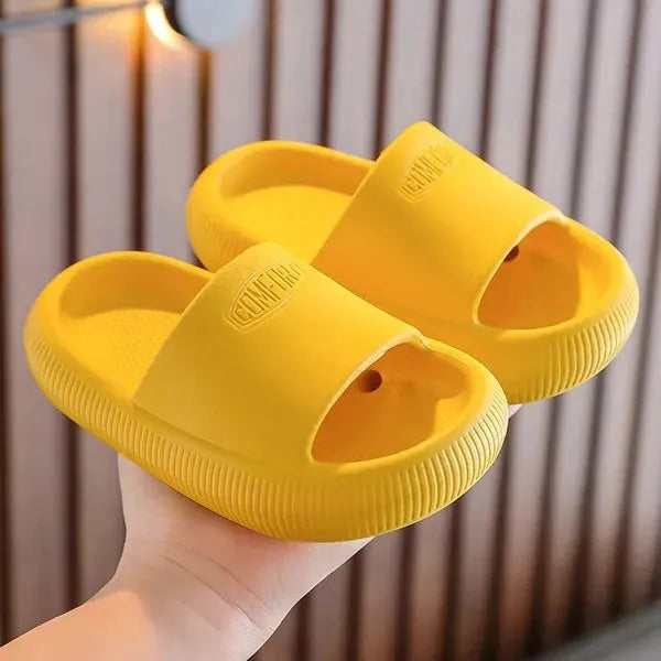 Children's bright coloured EVA slippers with a thick non-slip sole on a white background.