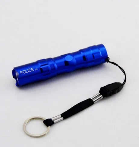 Compact black aluminium LED mini flashlight with keyring, shown next to a AA battery for scale.