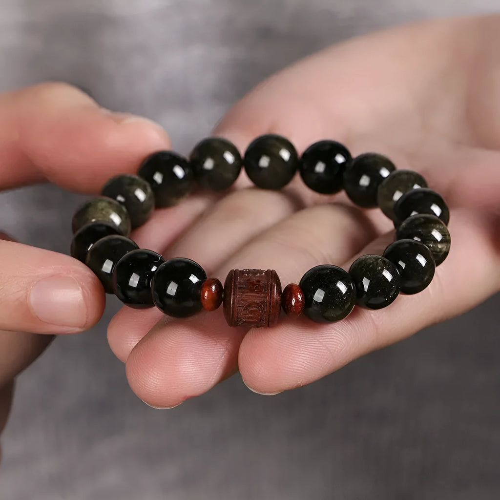 Golden obsidian vintage bracelet with hand-woven construction and national style design elements