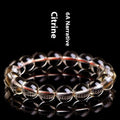 Natural citrine scattered beads ball bracelet on wrist, showing polished beads in 7A grade colour.