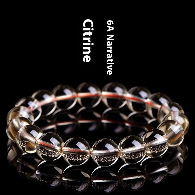 Natural citrine scattered bead bracelet showing spherical gemstone beads in golden colour.