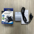 White ABS PS5 handle power bank with Type-C port and LED indicator, attached to a PS5 controller