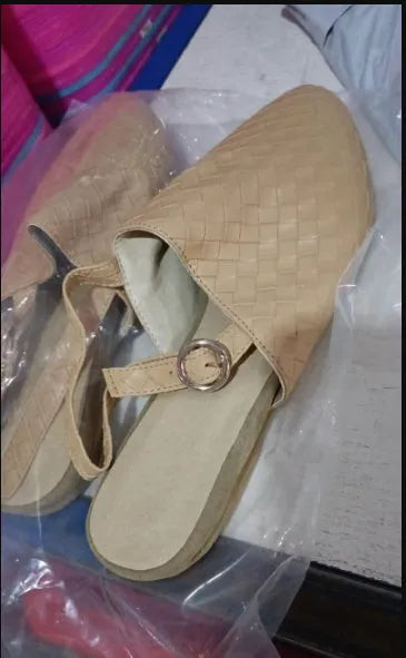 A pair of flat, pointed-toe sandals with a buckle fastening, shown in a choice of colours.