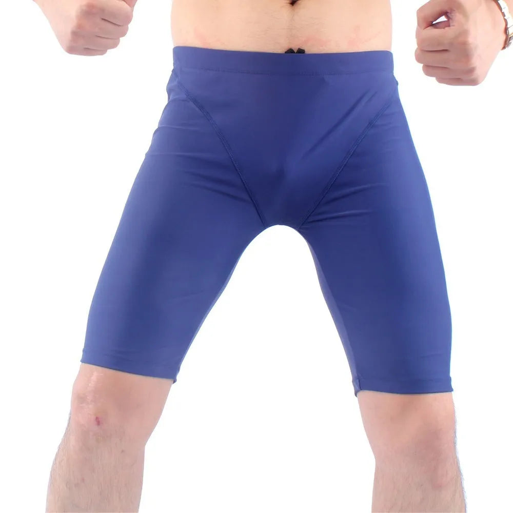 Men's green quick-drying nylon swimming trunks with loose five-point fit on a white background