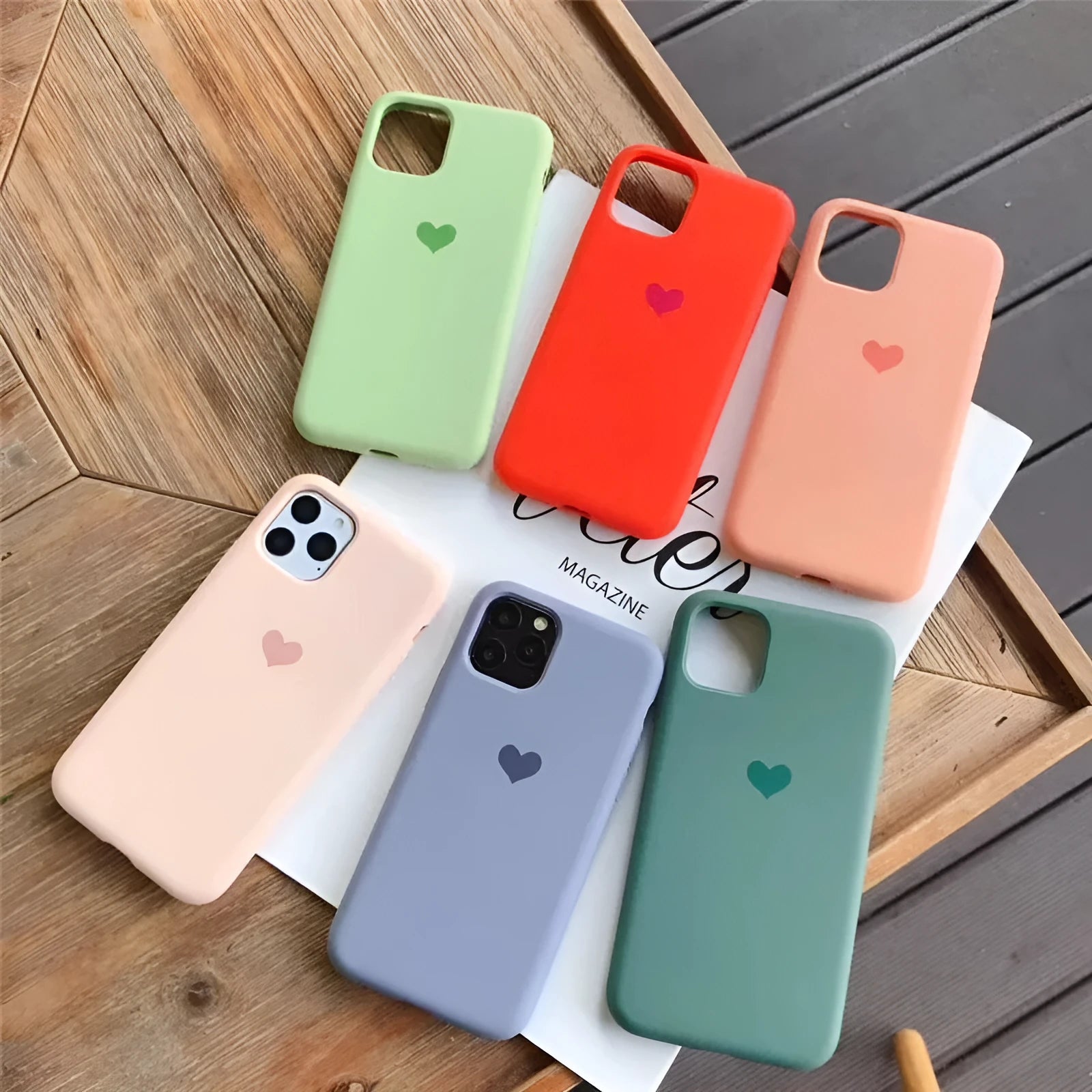 Solid colour silicone phone case for iPhone, shown in dark green, on a table next to an iPhone.