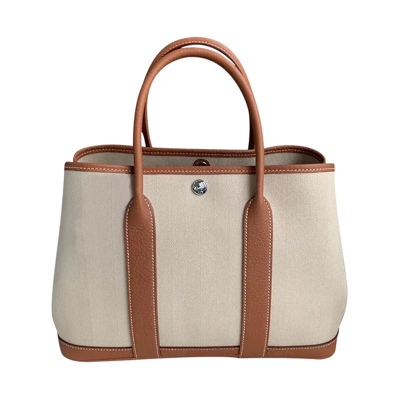 Women's canvas bucket tote bag with leather trim showing 25cm and 30cm size options