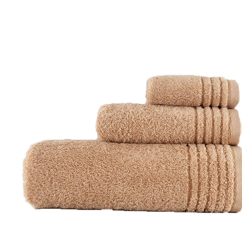 Beige and brown cotton towel set showing face cloth, hand towel and bath towel sizes.