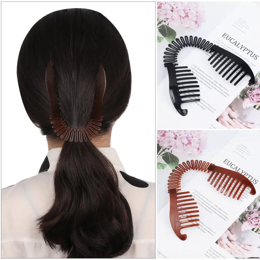 Retro fish-shaped hair claw clip in black with metal accents and adjustable hairband on a flat surface