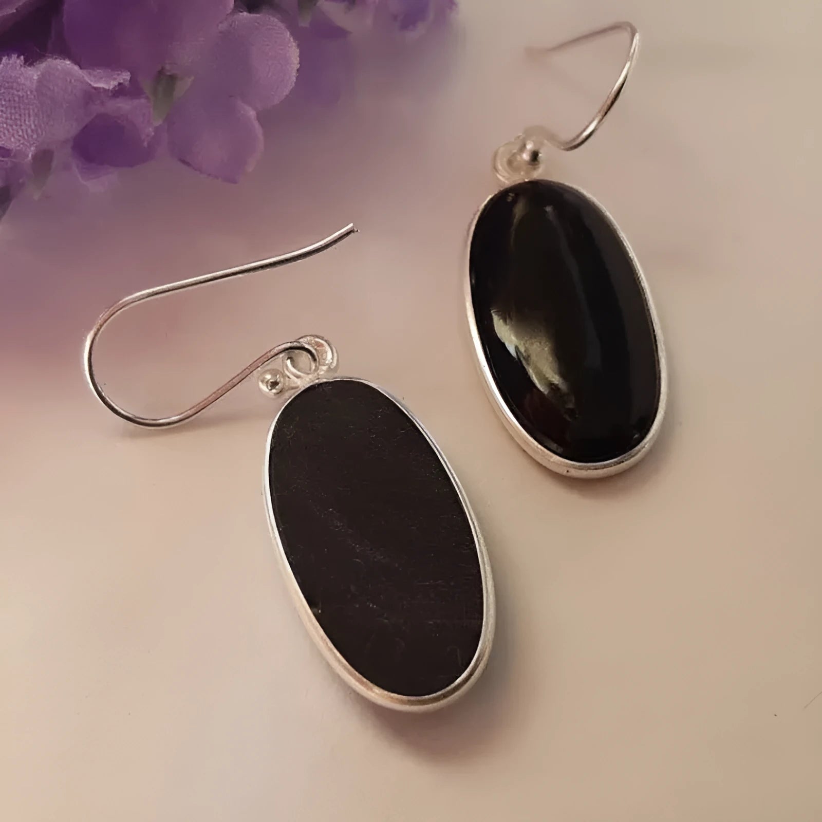 Black oval geometric earrings with Chinese style design on an electroplated alloy construction.