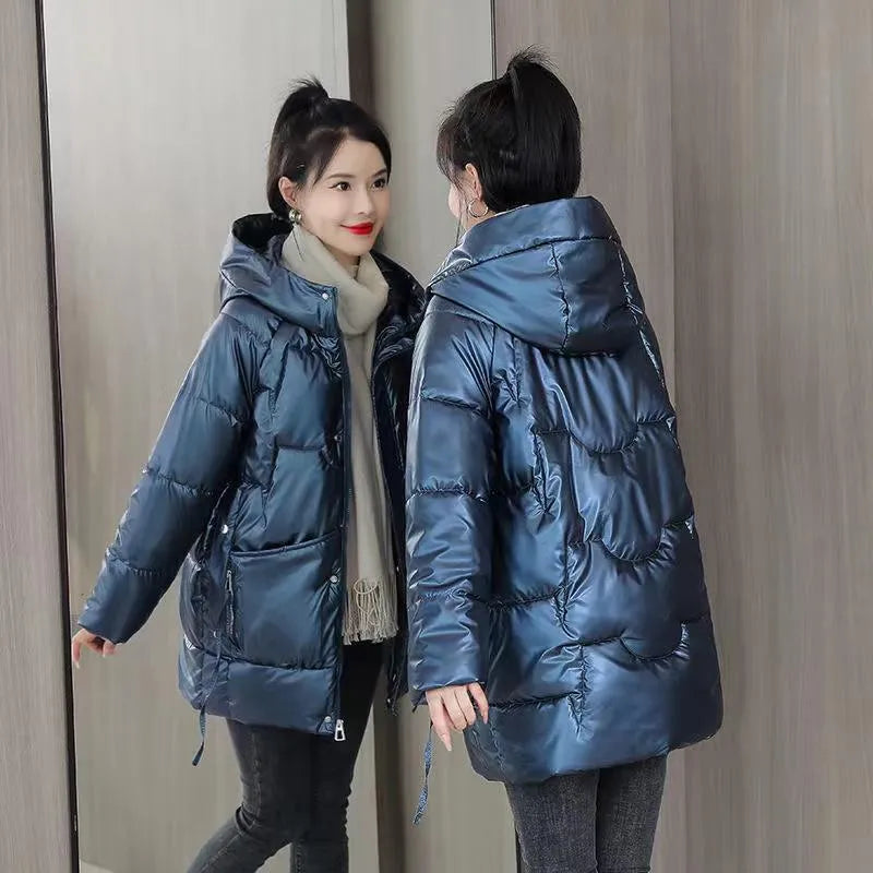 Women's loose thick hooded winter jacket in green, shown on a hanger.