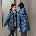 Women's loose thick hooded winter jacket in green, shown on a hanger.