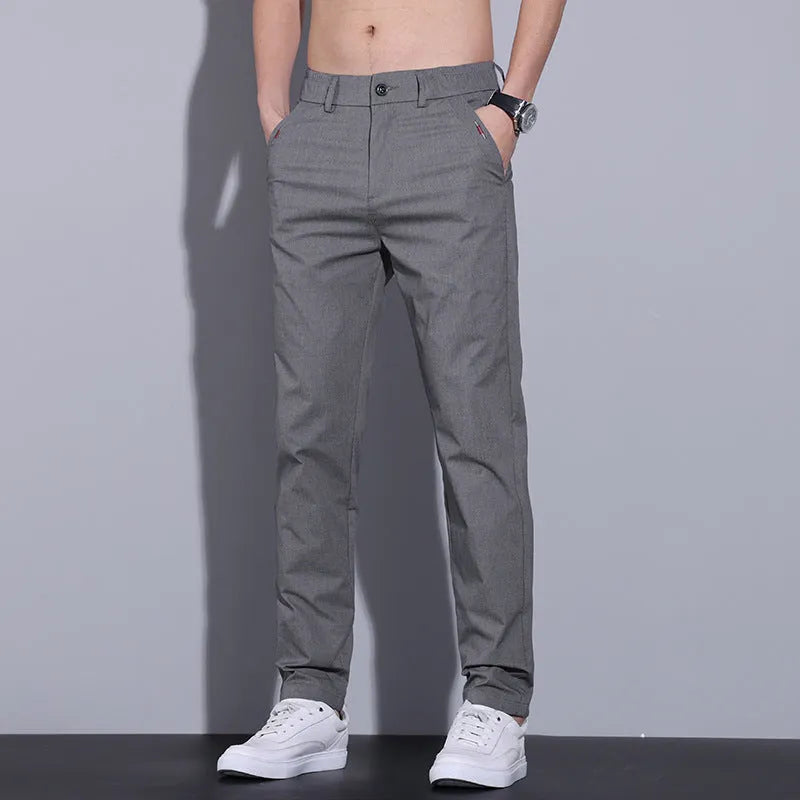 Men's straight slim fit cotton casual trousers in light khaki colour, laid flat.